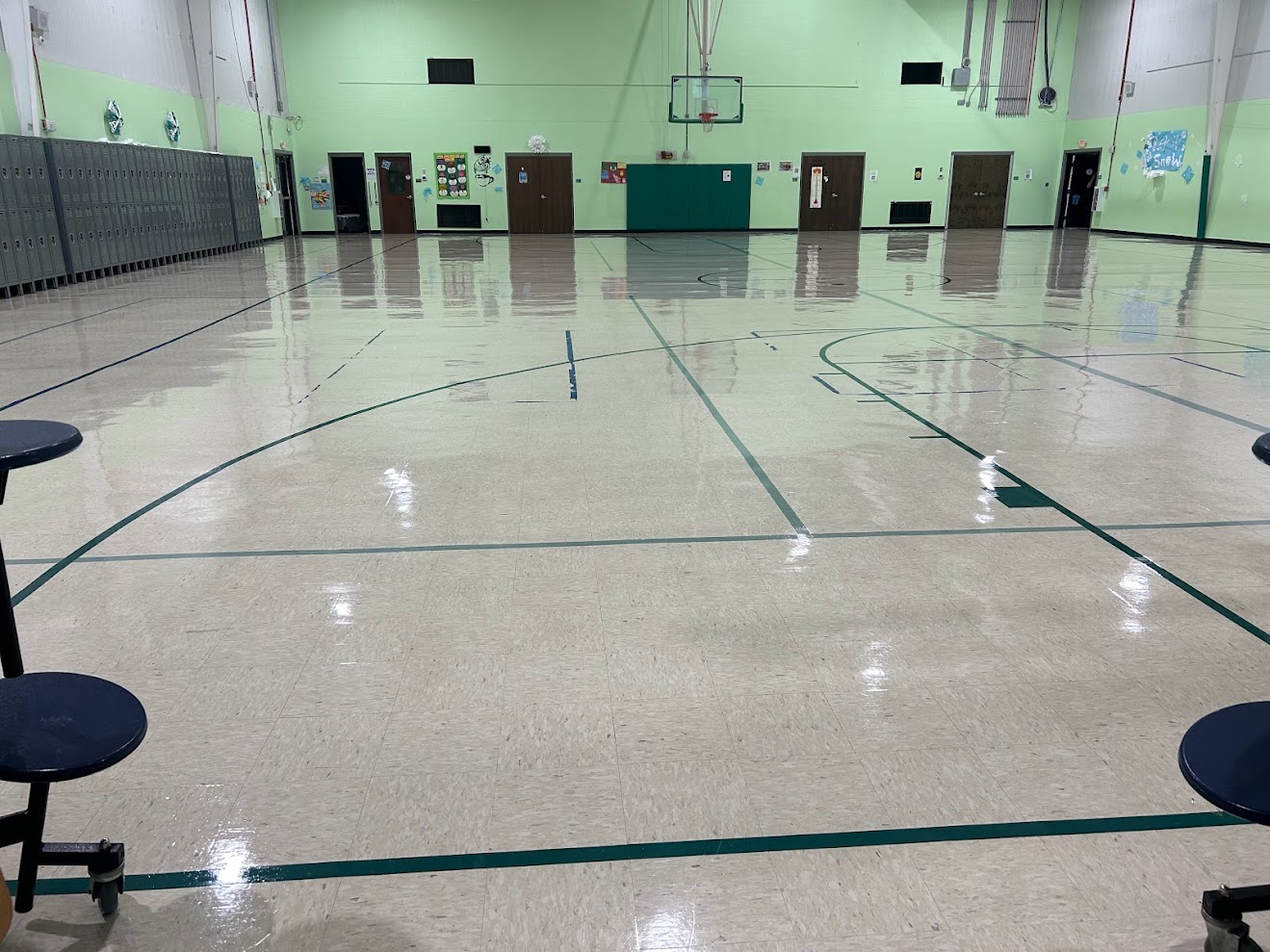 Glossy gymnasium floor after professional stripping and waxing